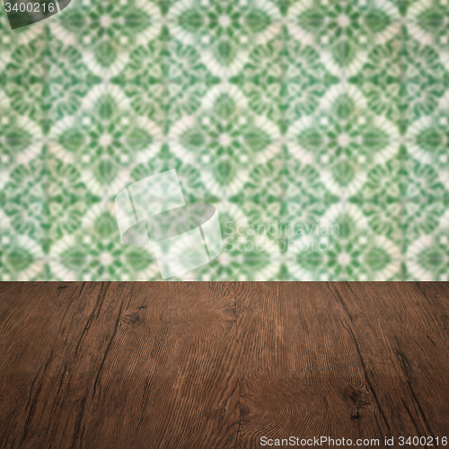 Image of Wood table top and blur vintage ceramic tile pattern wall