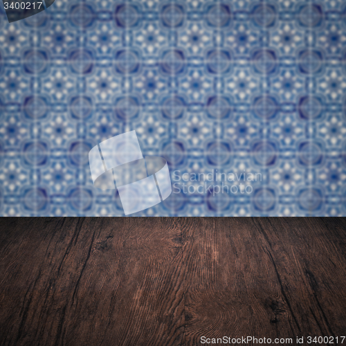Image of Wood table top and blur vintage ceramic tile pattern wall