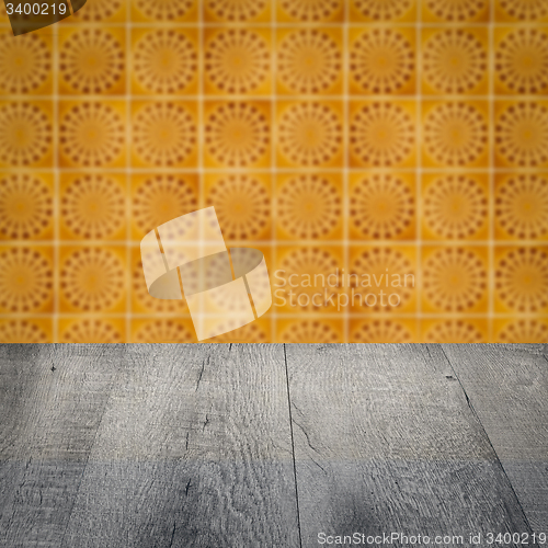 Image of Wood table top and blur vintage ceramic tile pattern wall