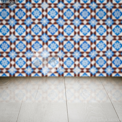 Image of Wood table top and blur vintage ceramic tile pattern wall