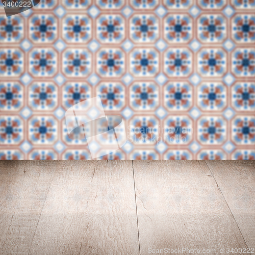 Image of Wood table top and blur vintage ceramic tile pattern wall