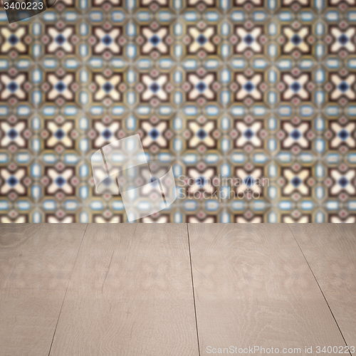 Image of Wood table top and blur vintage ceramic tile pattern wall