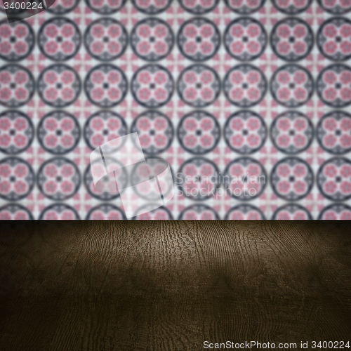 Image of Wood table top and blur vintage ceramic tile pattern wall