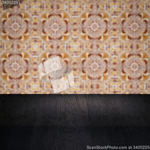 Image of Wood table top and blur vintage ceramic tile pattern wall