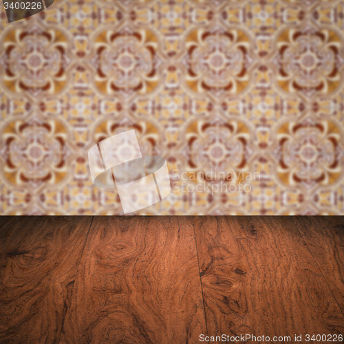 Image of Wood table top and blur vintage ceramic tile pattern wall