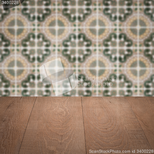 Image of Wood table top and blur vintage ceramic tile pattern wall