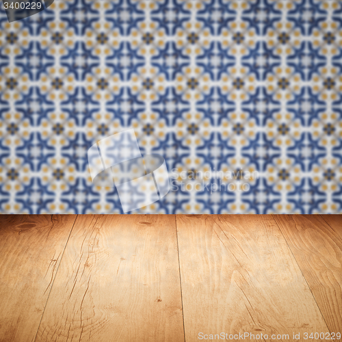 Image of Wood table top and blur vintage ceramic tile pattern wall