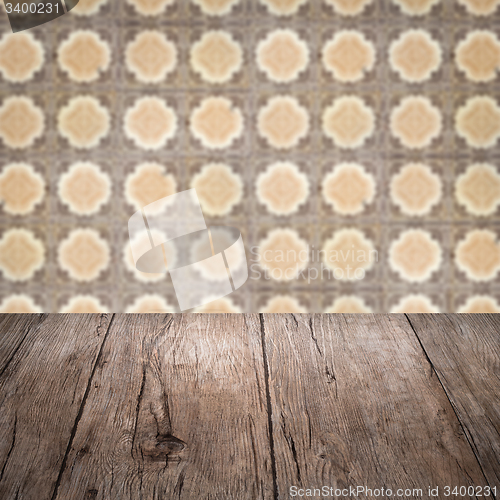 Image of Wood table top and blur vintage ceramic tile pattern wall