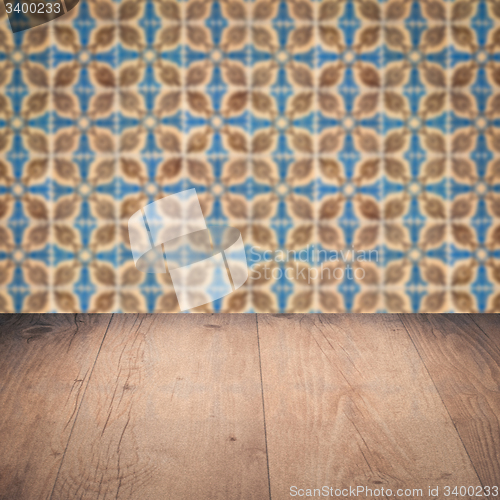 Image of Wood table top and blur vintage ceramic tile pattern wall