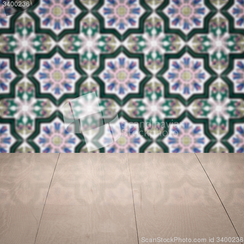 Image of Wood table top and blur vintage ceramic tile pattern wall