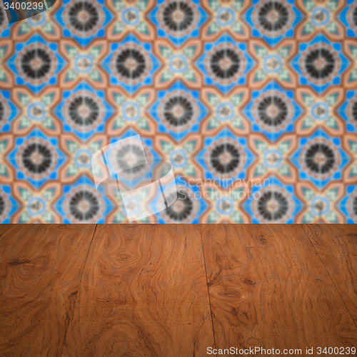 Image of Wood table top and blur vintage ceramic tile pattern wall