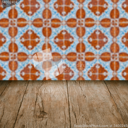 Image of Wood table top and blur vintage ceramic tile pattern wall