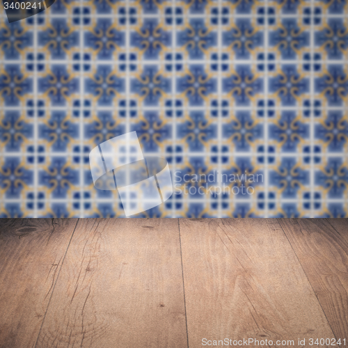 Image of Wood table top and blur vintage ceramic tile pattern wall