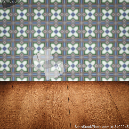 Image of Wood table top and blur vintage ceramic tile pattern wall