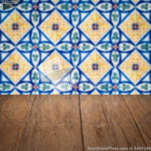 Image of Wood table top and blur vintage ceramic tile pattern wall