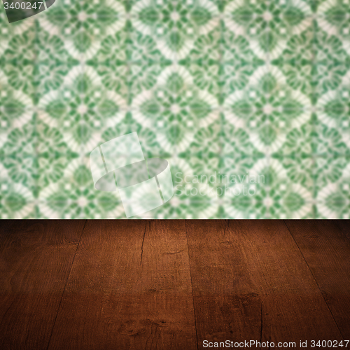 Image of Wood table top and blur vintage ceramic tile pattern wall