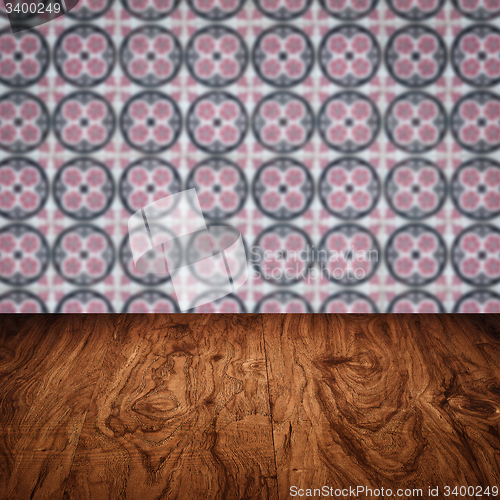 Image of Wood table top and blur vintage ceramic tile pattern wall