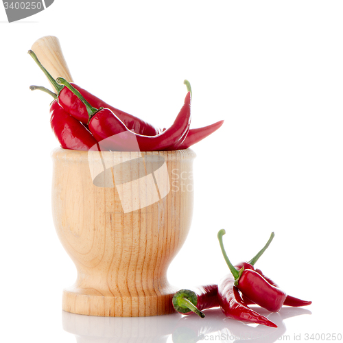 Image of Red chili in wooden mortar 