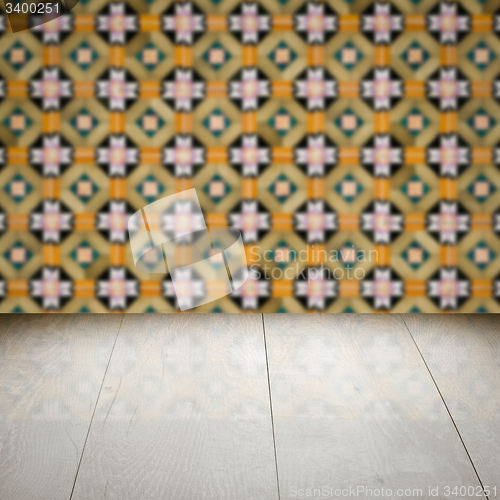 Image of Wood table top and blur vintage ceramic tile pattern wall