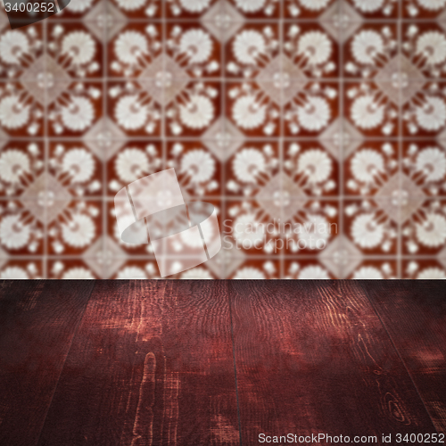 Image of Wood table top and blur vintage ceramic tile pattern wall