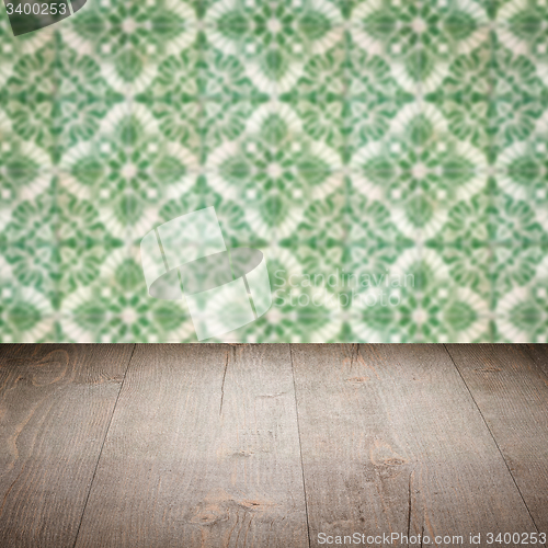 Image of Wood table top and blur vintage ceramic tile pattern wall