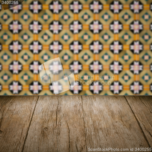 Image of Wood table top and blur vintage ceramic tile pattern wall