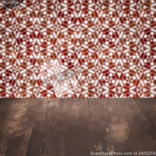 Image of Wood table top and blur vintage ceramic tile pattern wall