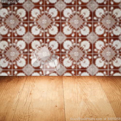 Image of Wood table top and blur vintage ceramic tile pattern wall