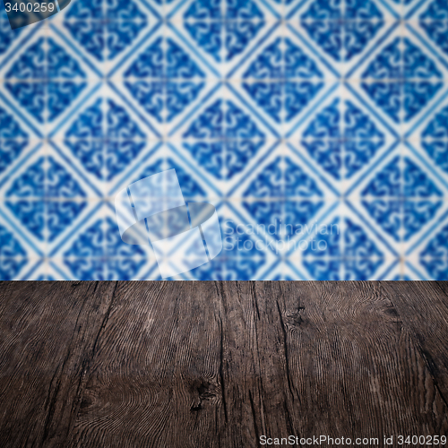 Image of Wood table top and blur vintage ceramic tile pattern wall