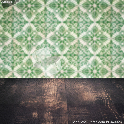 Image of Wood table top and blur vintage ceramic tile pattern wall