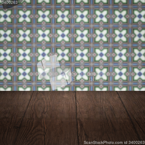 Image of Wood table top and blur vintage ceramic tile pattern wall
