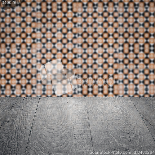Image of Wood table top and blur vintage ceramic tile pattern wall