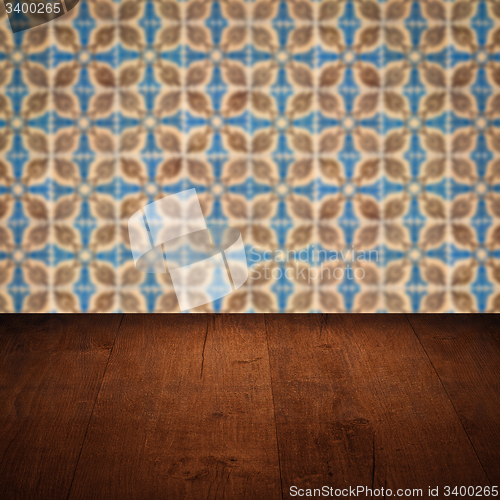Image of Wood table top and blur vintage ceramic tile pattern wall