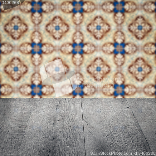 Image of Wood table top and blur vintage ceramic tile pattern wall