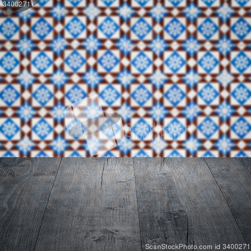 Image of Wood table top and blur vintage ceramic tile pattern wall