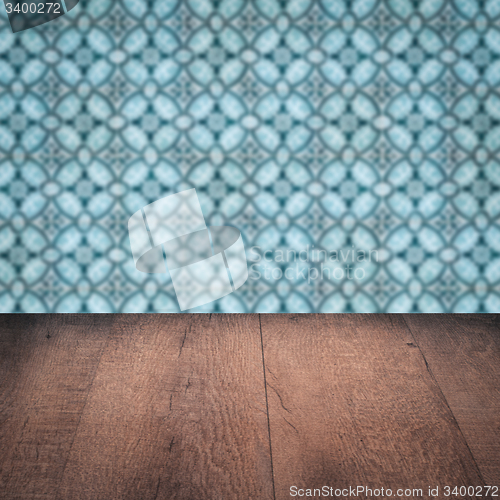 Image of Wood table top and blur vintage ceramic tile pattern wall