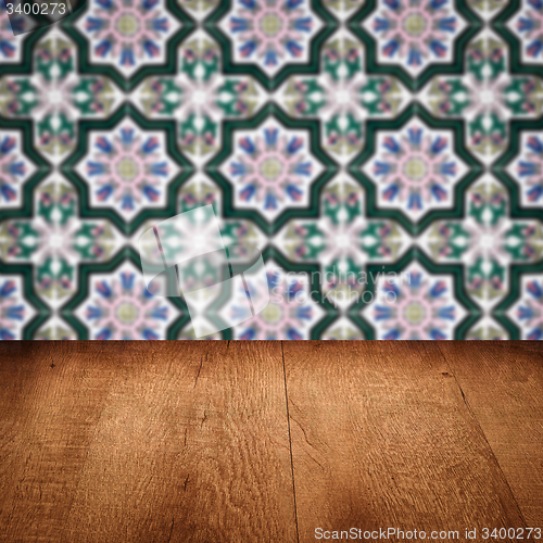 Image of Wood table top and blur vintage ceramic tile pattern wall