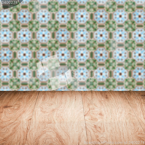 Image of Wood table top and blur vintage ceramic tile pattern wall
