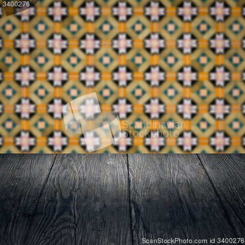 Image of Wood table top and blur vintage ceramic tile pattern wall