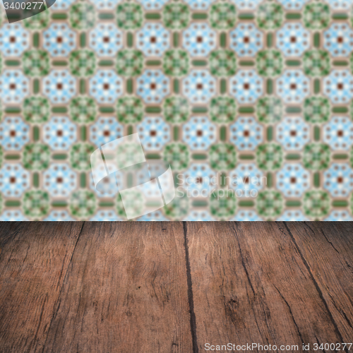 Image of Wood table top and blur vintage ceramic tile pattern wall