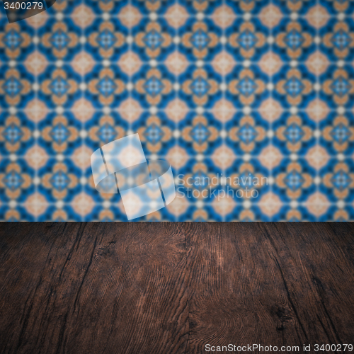 Image of Wood table top and blur vintage ceramic tile pattern wall