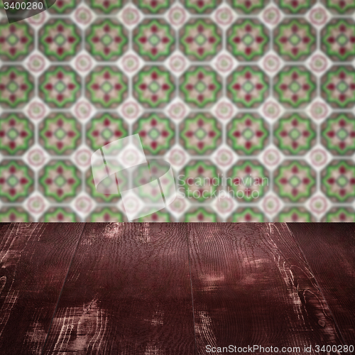 Image of Wood table top and blur vintage ceramic tile pattern wall