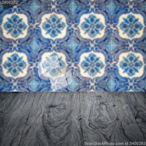 Image of Wood table top and blur vintage ceramic tile pattern wall