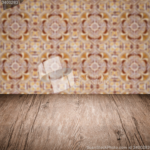Image of Wood table top and blur vintage ceramic tile pattern wall