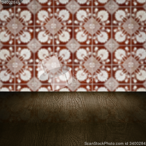 Image of Wood table top and blur vintage ceramic tile pattern wall