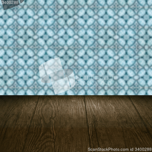 Image of Wood table top and blur vintage ceramic tile pattern wall