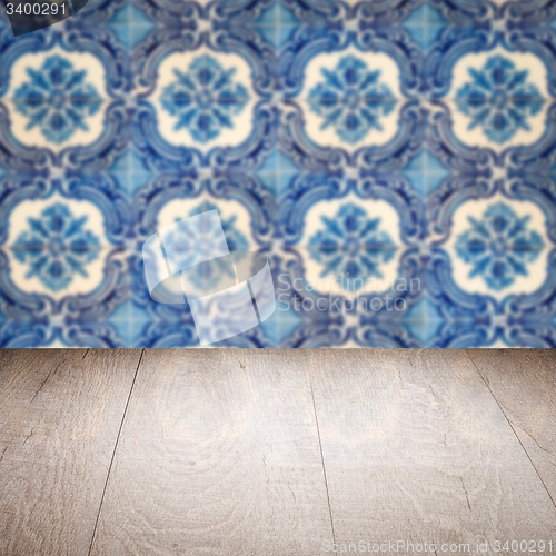 Image of Wood table top and blur vintage ceramic tile pattern wall