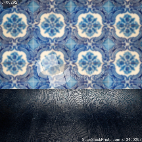 Image of Wood table top and blur vintage ceramic tile pattern wall