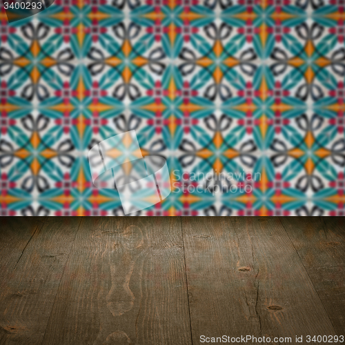 Image of Wood table top and blur vintage ceramic tile pattern wall