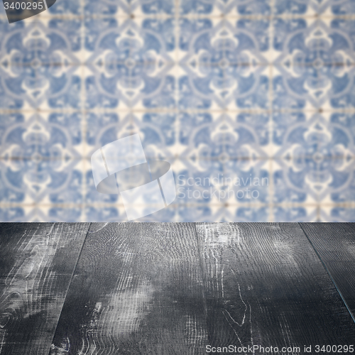 Image of Wood table top and blur vintage ceramic tile pattern wall
